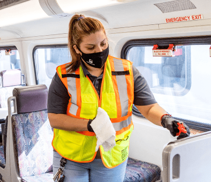 Metrolink employee disinfecting the train